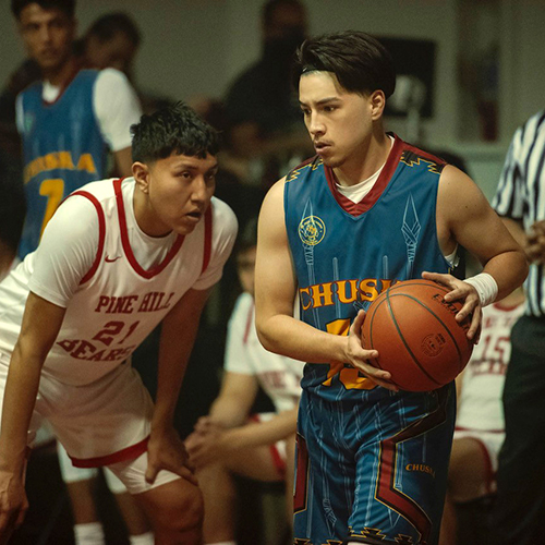 Two high school basketball players on the court